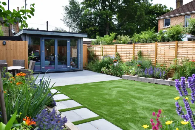 backyard designed with pavers and artificial turf strips